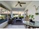 Cozy screened porch with seating area and dining table at 2870 Rampart Cir, Clearwater, FL 33761