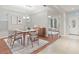 Dining room with hardwood floors, modern table, and access to office at 4104 Warwick Hills Dr, Wesley Chapel, FL 33543