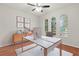 Bright home office with hardwood floors, large windows, and modern desk at 4104 Warwick Hills Dr, Wesley Chapel, FL 33543