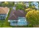 Home with brown roof, screened pool and spa, and lush landscaping at 16310 Ashington Park Dr, Tampa, FL 33647