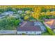 Home with brown roof, screened pool and lush landscaping at 16310 Ashington Park Dr, Tampa, FL 33647