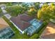 Home with brown roof, screened pool and spa, and surrounding trees at 16310 Ashington Park Dr, Tampa, FL 33647