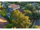 House with brown roof, screened pool, and surrounding trees at 16310 Ashington Park Dr, Tampa, FL 33647