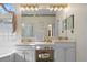 Bathroom with double vanity, large mirror, and plenty of counter space at 16310 Ashington Park Dr, Tampa, FL 33647