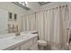 Bathroom with beige shower curtain and white vanity at 16310 Ashington Park Dr, Tampa, FL 33647