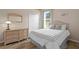Bright bedroom with wicker furniture and double doors at 16310 Ashington Park Dr, Tampa, FL 33647