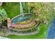 Ashton community entrance with brick signage and colorful landscaping at 16310 Ashington Park Dr, Tampa, FL 33647