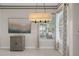 Bright dining area with large window and decorative light fixture at 16310 Ashington Park Dr, Tampa, FL 33647