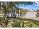 House exterior showcasing a manicured lawn and mature oak trees at 16310 Ashington Park Dr, Tampa, FL 33647