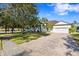 Landscaped front yard, brick driveway, and a charming house exterior at 16310 Ashington Park Dr, Tampa, FL 33647