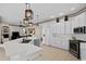 Modern kitchen with white cabinets, stainless steel appliances and a large island at 16310 Ashington Park Dr, Tampa, FL 33647