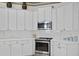 Well-equipped kitchen with white cabinets, stainless steel appliances at 16310 Ashington Park Dr, Tampa, FL 33647