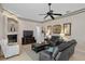 Cozy living room with fireplace, comfortable seating, and a large TV at 16310 Ashington Park Dr, Tampa, FL 33647