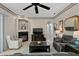 Spacious living room features a fireplace, built-in shelving and views of the pool at 16310 Ashington Park Dr, Tampa, FL 33647