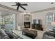 Bright living room with fireplace, pool view, and sliding glass doors at 16310 Ashington Park Dr, Tampa, FL 33647