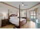Main bedroom with a post bed, ample natural light, and access to the pool at 16310 Ashington Park Dr, Tampa, FL 33647