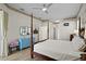 Main bedroom with a post bed, dresser, and access to the pool area at 16310 Ashington Park Dr, Tampa, FL 33647