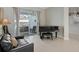 Relaxing music room with piano, leather couch, and backyard access at 16310 Ashington Park Dr, Tampa, FL 33647
