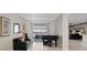 Music room with a grand piano and sliding glass doors to the pool area at 16310 Ashington Park Dr, Tampa, FL 33647