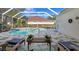 Inviting pool area with screened enclosure and lounge chairs at 16310 Ashington Park Dr, Tampa, FL 33647