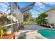Peaceful pool area with screened enclosure and lush plants at 16310 Ashington Park Dr, Tampa, FL 33647