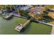 Aerial view of waterfront home with private dock and lush landscaping at 16323 Redington Dr, Redington Beach, FL 33708