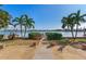 Landscaped backyard with water access and lush tropical plants at 16323 Redington Dr, Redington Beach, FL 33708