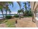 Spacious patio overlooking the water with lush landscaping at 16323 Redington Dr, Redington Beach, FL 33708