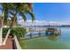Inviting waterfront view with private dock and lush landscaping at 16323 Redington Dr, Redington Beach, FL 33708