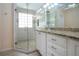 Spa-like bathroom with a large shower and granite vanity at 324 Caloosa Palms Ct, Sun City Center, FL 33573