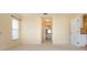 Bright bedroom with view into bathroom and hallway at 324 Caloosa Palms Ct, Sun City Center, FL 33573