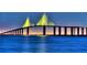 Night view of a lit-up bridge over the water at 324 Caloosa Palms Ct, Sun City Center, FL 33573