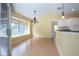 Bright dining room with large window and wood flooring at 324 Caloosa Palms Ct, Sun City Center, FL 33573