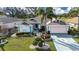 Charming one-story home featuring a 2-car garage, inviting facade, and lush landscaping at 324 Caloosa Palms Ct, Sun City Center, FL 33573