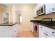 Kitchen features stainless steel appliances and granite countertops at 324 Caloosa Palms Ct, Sun City Center, FL 33573