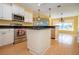 Kitchen with island, stainless steel appliances, and granite counters at 324 Caloosa Palms Ct, Sun City Center, FL 33573