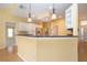 Kitchen features granite countertop and breakfast bar at 324 Caloosa Palms Ct, Sun City Center, FL 33573