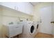Laundry room with washer, dryer, and utility sink at 324 Caloosa Palms Ct, Sun City Center, FL 33573