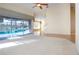 Bright living room with pool view, hardwood floors, and high ceilings at 324 Caloosa Palms Ct, Sun City Center, FL 33573