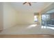 Sunlit living room with hardwood and carpeted floors, and sliding glass doors at 324 Caloosa Palms Ct, Sun City Center, FL 33573