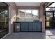 Outdoor kitchen features a sink, mini-fridge, and grill at 324 Caloosa Palms Ct, Sun City Center, FL 33573