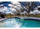 Inviting screened pool and spa with tranquil golf course views at 324 Caloosa Palms Ct, Sun City Center, FL 33573