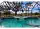 Inviting screened pool and spa with tranquil golf course views at 324 Caloosa Palms Ct, Sun City Center, FL 33573