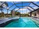 Inviting screened pool and spa with tranquil golf course views at 324 Caloosa Palms Ct, Sun City Center, FL 33573