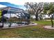 Landscaped backyard with screened pool and spa at 324 Caloosa Palms Ct, Sun City Center, FL 33573