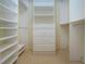 Bright walk-in closet with ample shelving and drawers at 324 Caloosa Palms Ct, Sun City Center, FL 33573