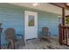Back porch with two chairs and a wooden floor at 394 Ulelah Ave, Palm Harbor, FL 34683