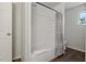 Clean bathroom with tub shower combo and grey shower curtain at 394 Ulelah Ave, Palm Harbor, FL 34683