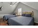 Upstairs bedroom with two twin beds and a ceiling fan at 394 Ulelah Ave, Palm Harbor, FL 34683