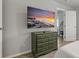 Bedroom with a dresser and large TV at 394 Ulelah Ave, Palm Harbor, FL 34683